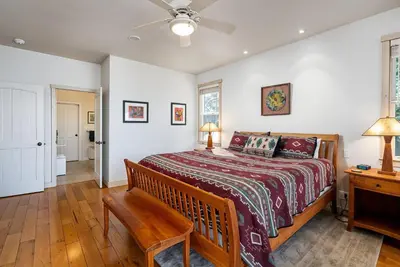 a bedroom with a bed and a ceiling fan at Lakefront Casa Cassaretto in Groveland