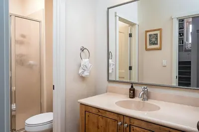 a bathroom with a sink and a toilet and a mirror at Lakefront Casa Cassaretto in Groveland