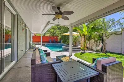 a patio with a table and chairs and a pool at Spacious Folsom Getaway with Pool and Hot Tub! in Folsom