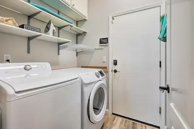 a white washer and dryer in a laundry room at Spacious Folsom Getaway with Pool and Hot Tub! in Folsom