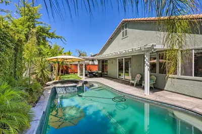 a swimming pool in front of a house at Spacious Folsom Getaway with Pool and Hot Tub! in Folsom