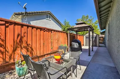 a patio with chairs and a gazebo at Spacious Folsom Getaway with Pool and Hot Tub! in Folsom