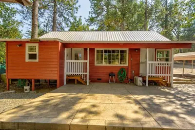 a red and white house with a porch at Acorn Cabin - Charming Place, Your getaway to Yosemite, Bass Lake in Oakhurst