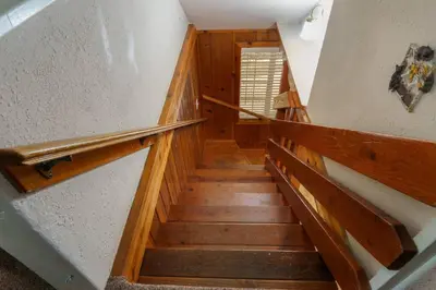a staircase in a house with wooden steps at Acorn Cabin - Charming Place, Your getaway to Yosemite, Bass Lake in Oakhurst