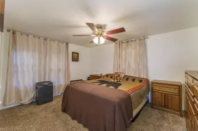 a bedroom with a bed and a ceiling fan at Acorn Cabin - Charming Place, Your getaway to Yosemite, Bass Lake in Oakhurst