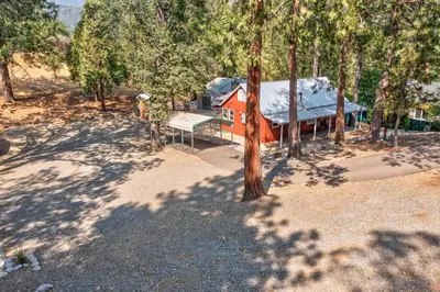 an aerial view of a house in the middle of trees at Acorn Cabin - Charming Place, Your getaway to Yosemite, Bass Lake in Oakhurst