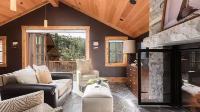 a living room with a couch and a fireplace at Hunter by AvantStay Award-Winning Riverfront Cabin 5 Minutes from Palisades in Olympic Valley