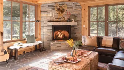 a living room with a couch and a fireplace at Hunter by AvantStay Award-Winning Riverfront Cabin 5 Minutes from Palisades in Olympic Valley