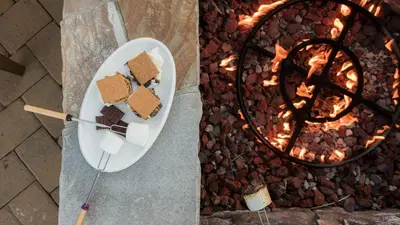 a plate of food next to a fire grill at Modern Mountain Home w Cozy Fire Pit 15 Mins frm Northstar Maple by AvantStay in Ponderosa Fairway Estates
