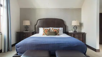 a bedroom with a large bed with two night stands at Modern Mountain Home w Cozy Fire Pit 15 Mins frm Northstar Maple by AvantStay in Ponderosa Fairway Estates