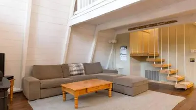 a living room with a couch and a coffee table at Zephyr by AvantStay Stylish Modified A Frame w Access To Tahoe Donner in Truckee