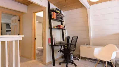 a room with a desk and a chair and a toilet at Zephyr by AvantStay Stylish Modified A Frame w Access To Tahoe Donner in Truckee