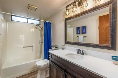 a bathroom with a sink and a toilet and a mirror at 3 Wild Turkeys Family Friendly Home in Groveland