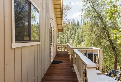 a wrap around porch of a house with trees at 3 Wild Turkeys Family Friendly Home in Groveland