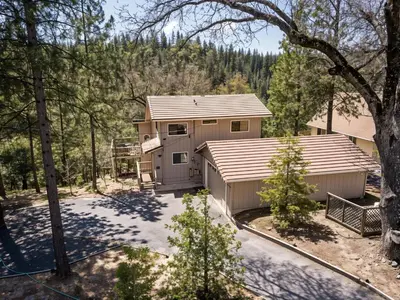 an aerial view of a house with trees at 3 Wild Turkeys Family Friendly Home in Groveland