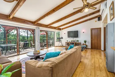 a living room with a couch and a tv at The Happy Place Mountain View Home in Groveland