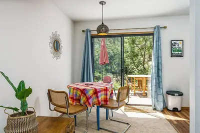 a dining room with a table and chairs and a window at The Happy Place Mountain View Home in Groveland