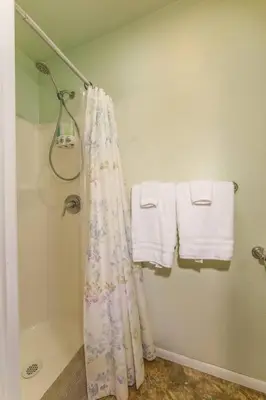 a bathroom with a shower curtain and towels at Acorn Cottage - Hidden gem in green heaven, getaway to Bass Lake & Yosemite in Oakhurst