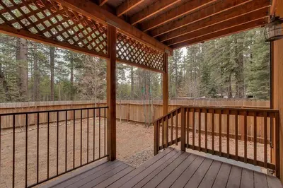 a screened porch of a cabin with a view of the woods at Lukins Lodge By The Lake Hot Tub in South Lake Tahoe