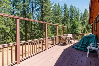 a wooden deck with a table and chairs on it at Pet Friendly The Hideout Yosemite Home in Groveland