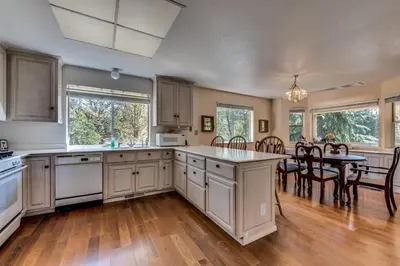 a large kitchen with a table and a dining room at Casa Del Lago - Only 200 Yards from the Beach in Groveland