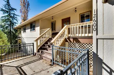 a house with a wooden staircase in front of it at Casa Del Lago - Only 200 Yards from the Beach in Groveland