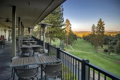 a row of tables and chairs on a balcony with a view at Casa Del Lago - Only 200 Yards from the Beach in Groveland
