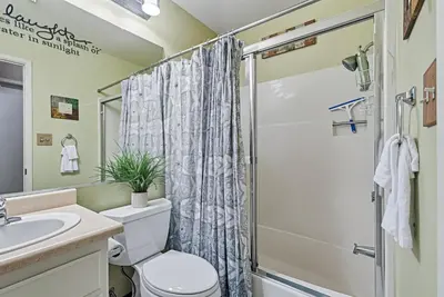 a bathroom with a shower and a toilet and a sink at Bigfoot Retreat Home Close to Beach in Groveland