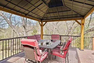 a patio with a table and chairs on a deck at Bigfoot Retreat Home Close to Beach in Groveland