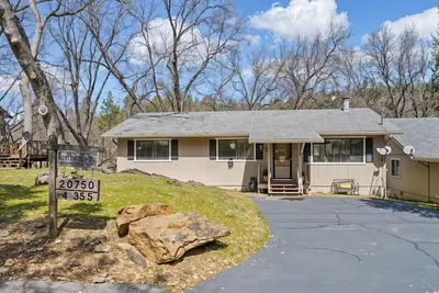 a house with a rock in front of it at Bigfoot Retreat Home Close to Beach in Groveland