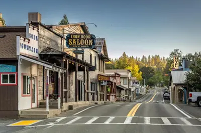 an empty street in a town with a sign for a shop at Bigfoot Retreat Home Close to Beach in Groveland