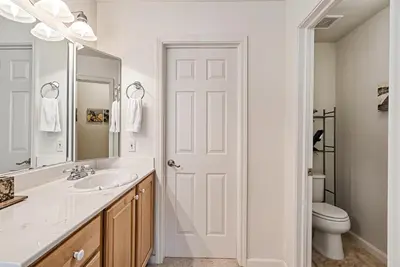 a white bathroom with a sink and a toilet at Star of the Mountain Yosemite Home in Groveland