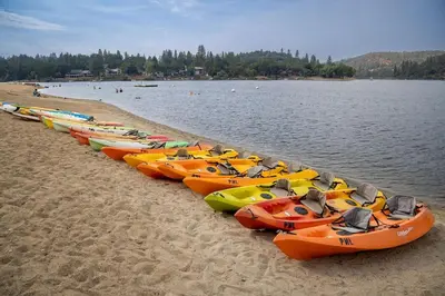 a row of kayaks lined up on a beach at Star of the Mountain Yosemite Home in Groveland