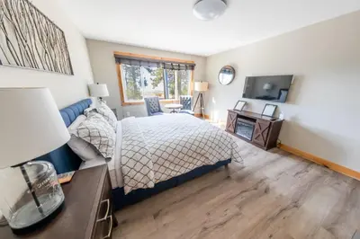a bedroom with a bed and a desk and a television at Lakeside hotel room #1 in Kings Beach in Kings Beach