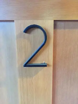 a blue number on a wooden door with a screw at Lakeside Hotel room #2 in Kings Beach in Kings Beach
