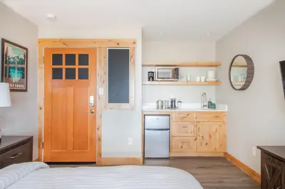 a kitchen with a bed and a wooden door at Lakeside hotel room #8 in Kings Beach in Kings Beach