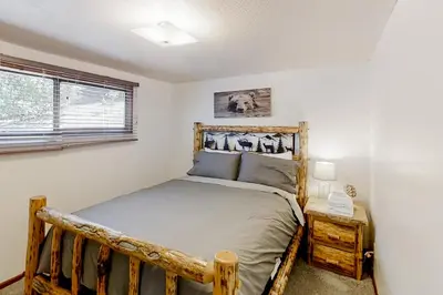 a bedroom with a wooden bed in a room at Sugar Pine Log Cabin in Oakhurst