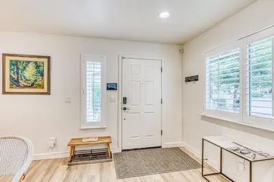 a living room with a white door and windows at Slide Creek Retreat in Bass Lake