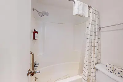 a bathroom with a tub and a shower curtain at Chamonix 20 in Mammoth Lakes
