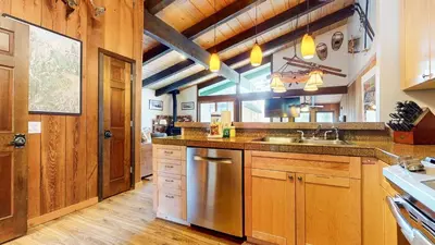 a large kitchen with wooden cabinets and a sink at Chateau Sans Nom #19 condo in Mammoth Lakes