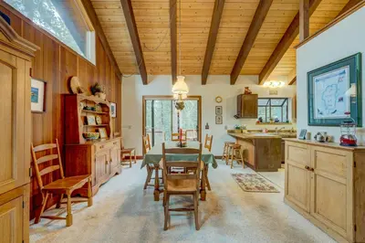 a kitchen and dining room with a table and chairs at Grizzly Cabin in Truckee