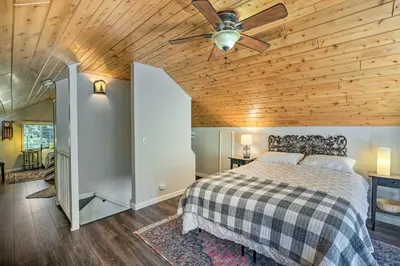 a bedroom with a bed and a wooden ceiling at 1 Mi to Jenkinson Lake Apples Chalet with Deck in Pollock Pines