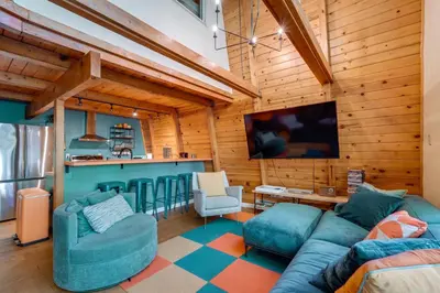 a living room with a couch and a tv at Charming Pinecrest Cabin with Private Deck in Strawberry