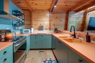 a kitchen with a sink and a stove at Charming Pinecrest Cabin with Private Deck in Strawberry