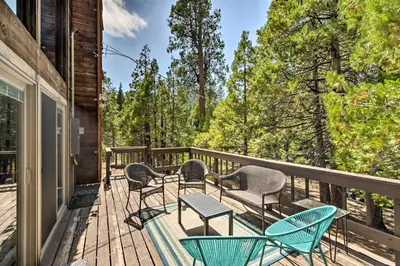 a deck with chairs and tables on a house at Charming Pinecrest Cabin with Private Deck in Strawberry