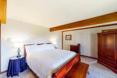 a bedroom with a large bed and a wooden cabinet at Tahoe Enchantment in Zephyr Cove