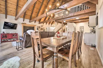 a kitchen and dining room with a wooden table and chairs at 2 Mi to Tahoe Donner Ski Resort Forest-View Haven in Truckee