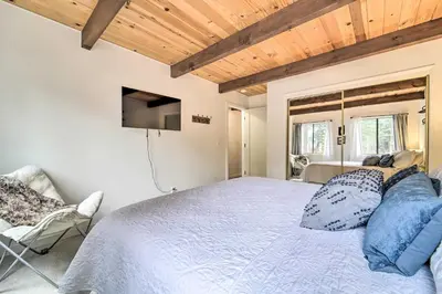 a bedroom with a large bed and a tv at 2 Mi to Tahoe Donner Ski Resort Forest-View Haven in Truckee
