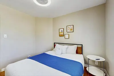 a bedroom with a large bed with blue and white sheets at Escape at Edgewood in Stateline