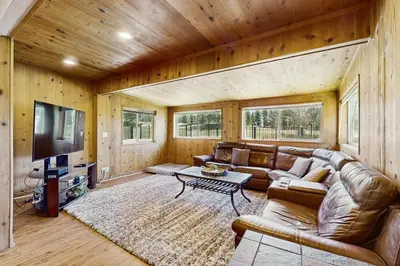 a living room with a leather couch and a television at Escape at Edgewood in Stateline